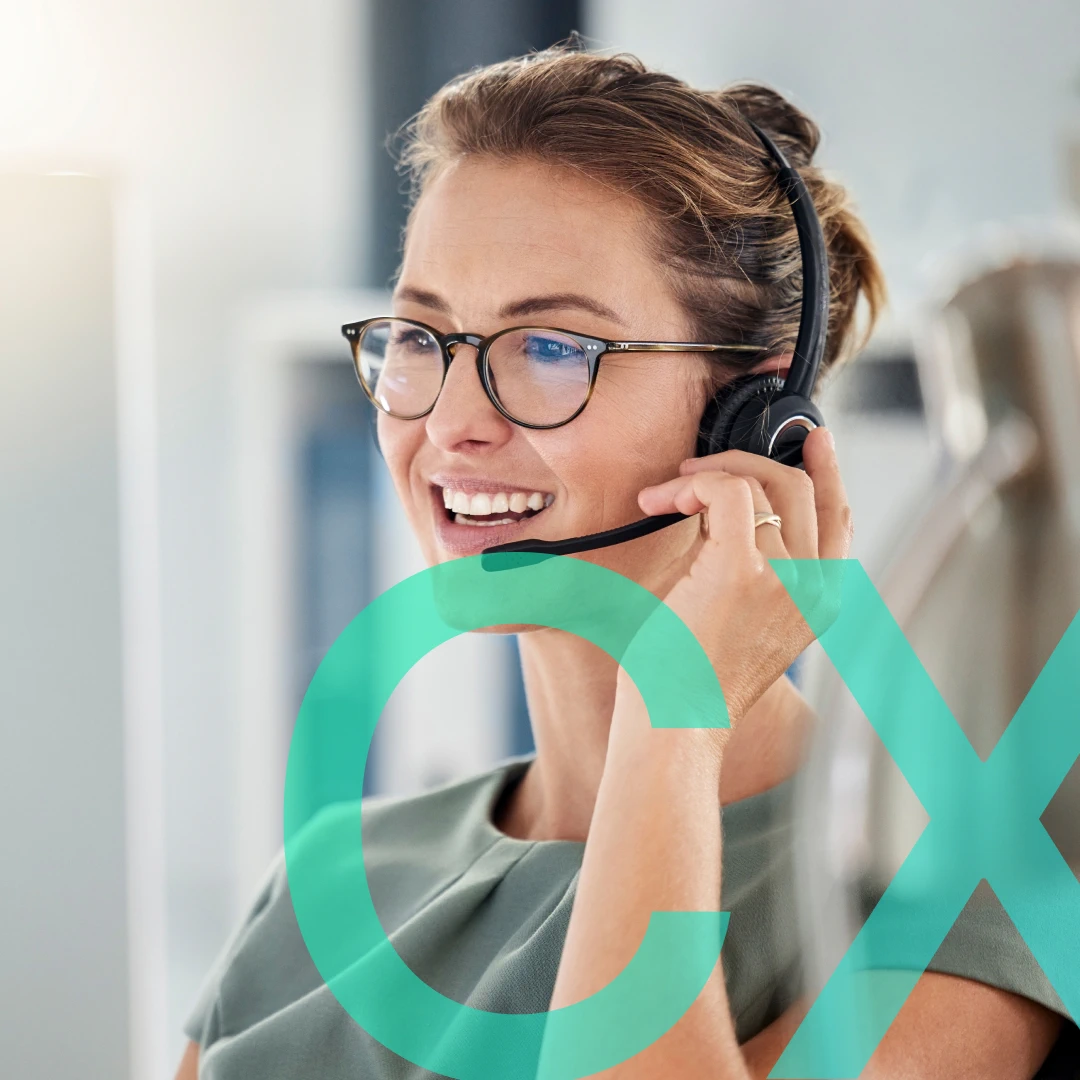 Smiling woman with glasses and headset providing CX consulting.