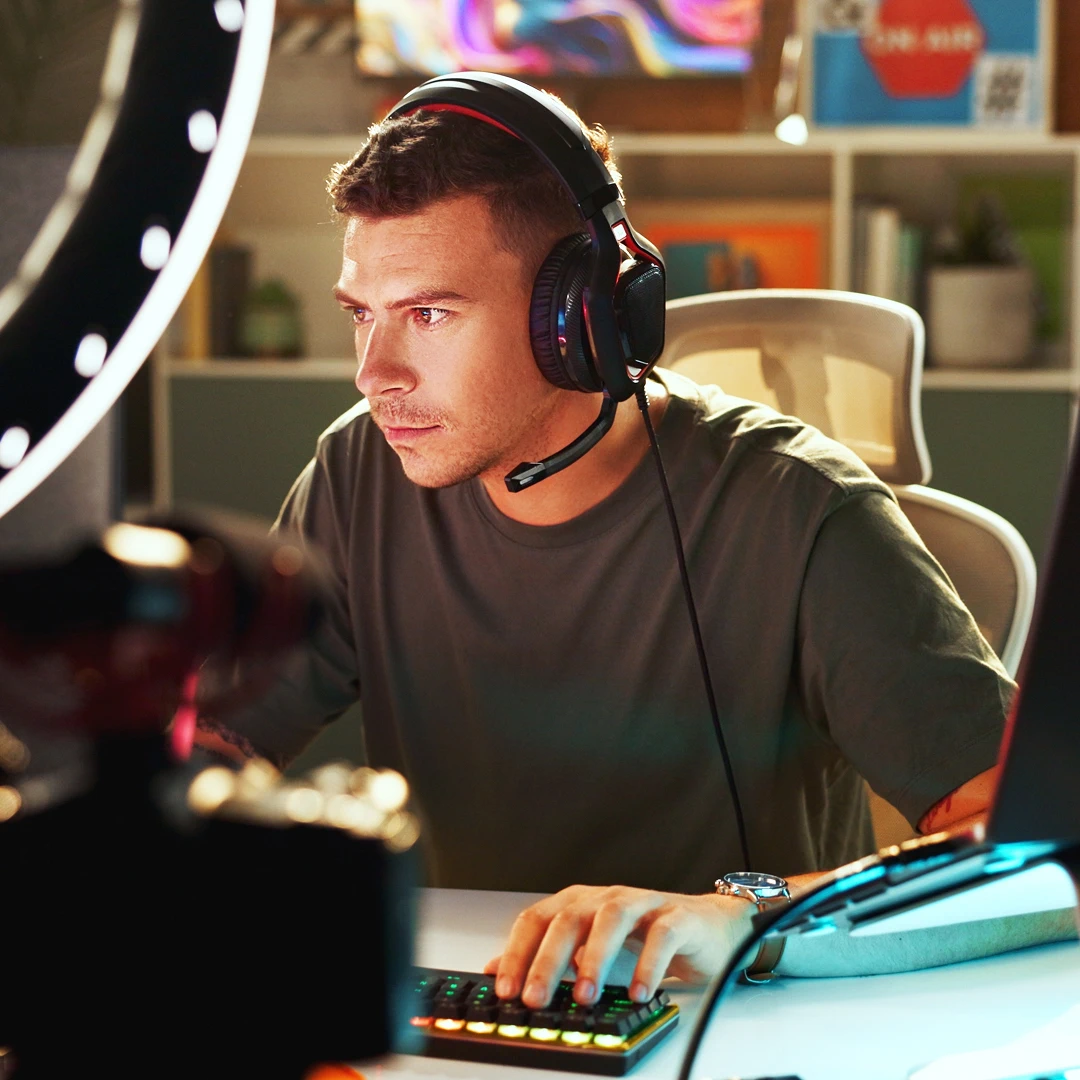 Gamer wearing a headset and playing a computer game