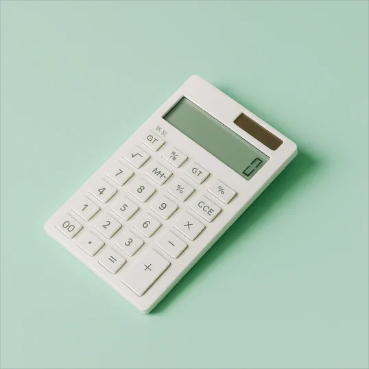White calculator on a light green surface.