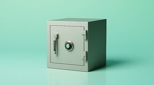 Gray metal safe placed against a green background