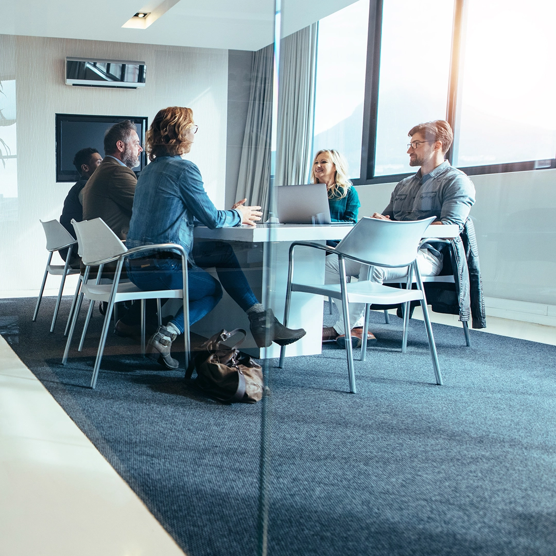 Business team collaborating in a light-filled office conference room