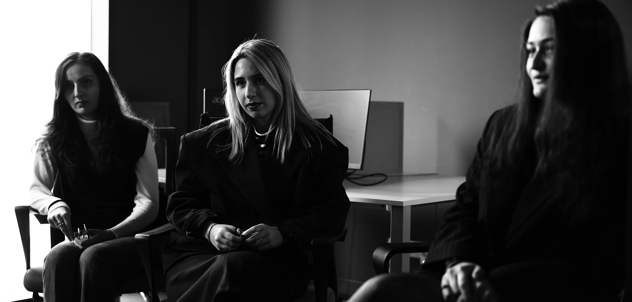 Three women in a meeting or office