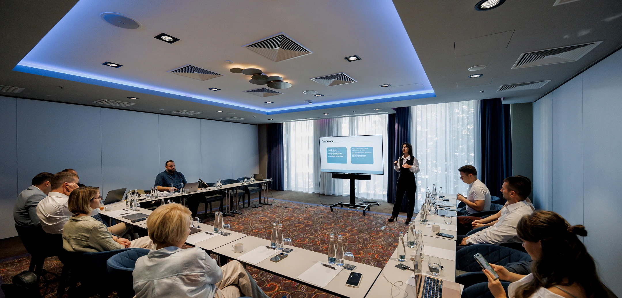 Business meeting of Helpware's leadership team in a spacious conference hall