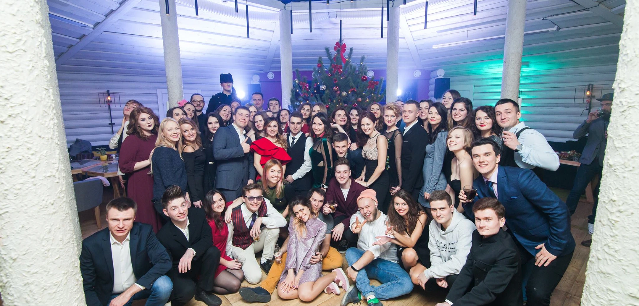 Group photo of Helpware team members at a New Year's corporate party, celebrating together.