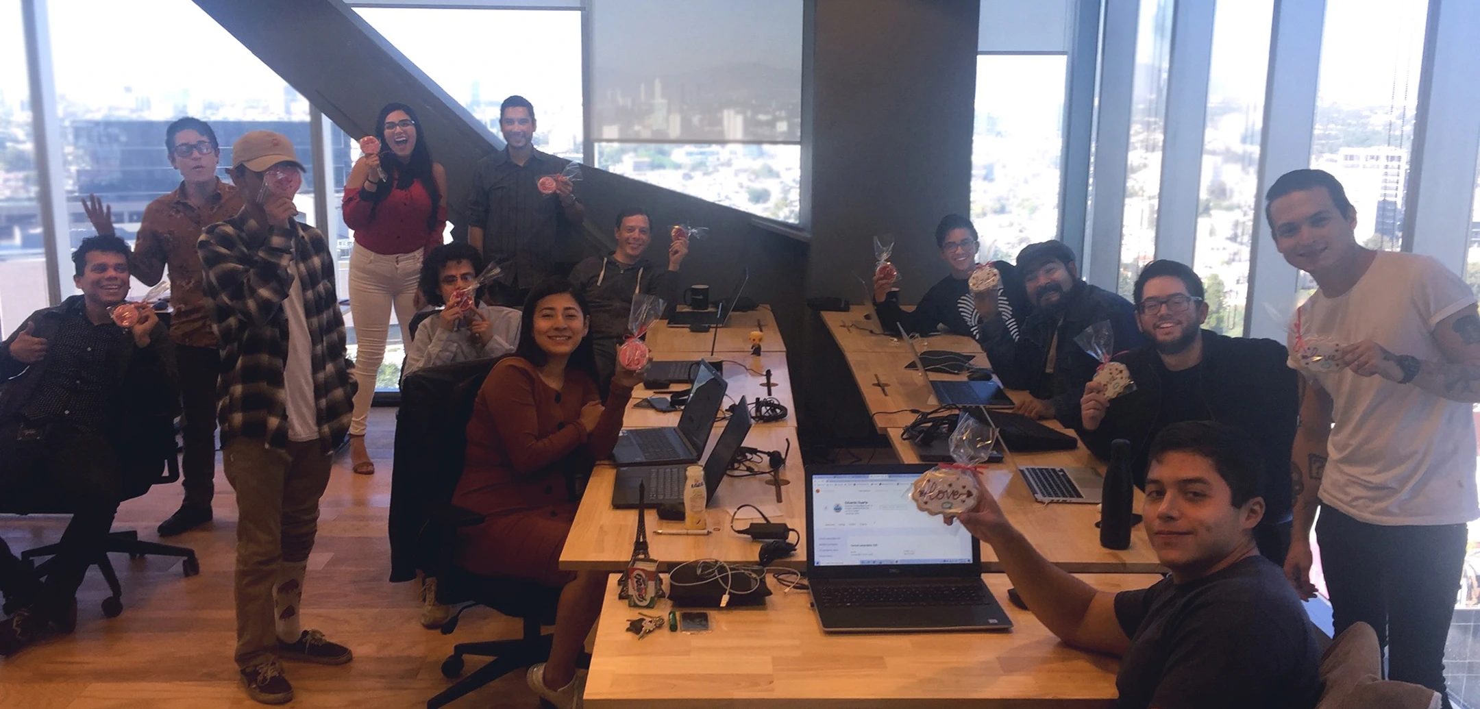 Group photo of Helpware team members holding gifts.