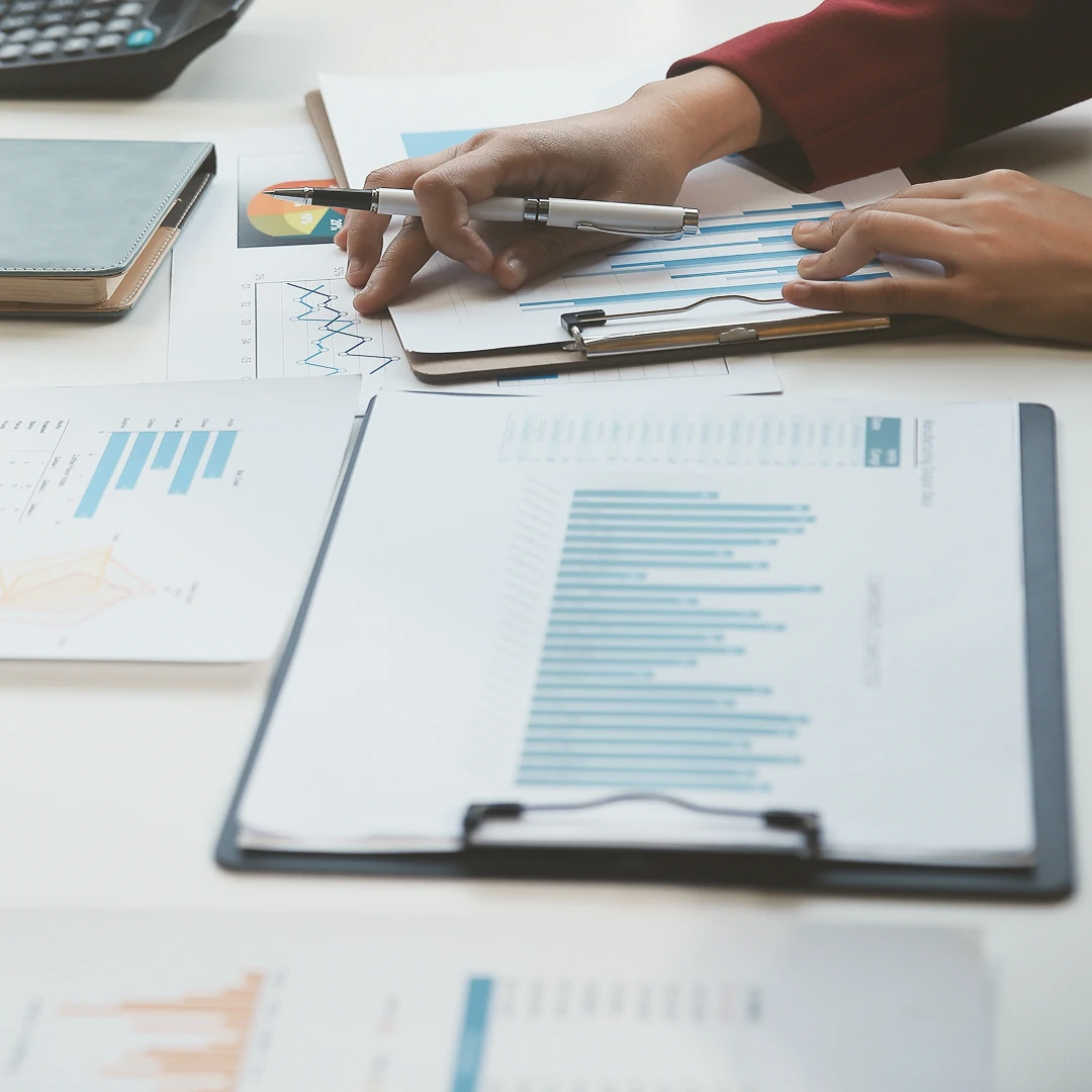 Person analyzing charts and graphs