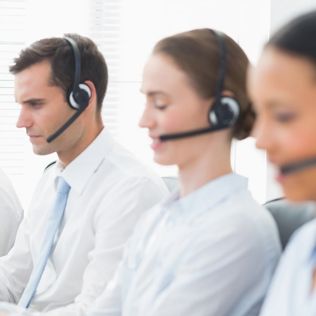 A team of customer support agents wearing white shirts provides diligent customer support