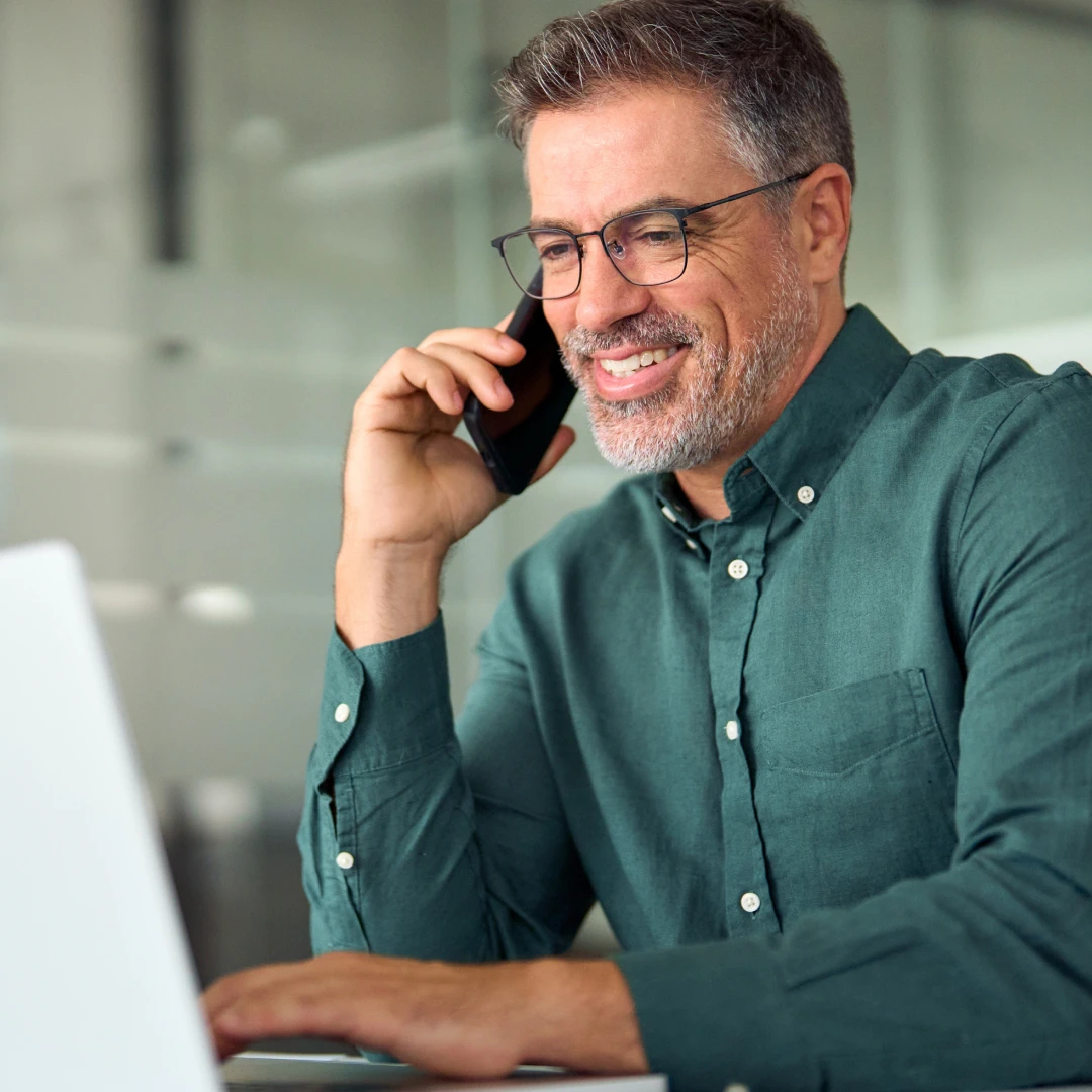 Customer support representative in green shirt handling calls in a modern Ukrainian call center