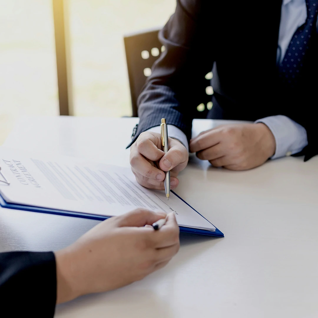 Business professional signing a document