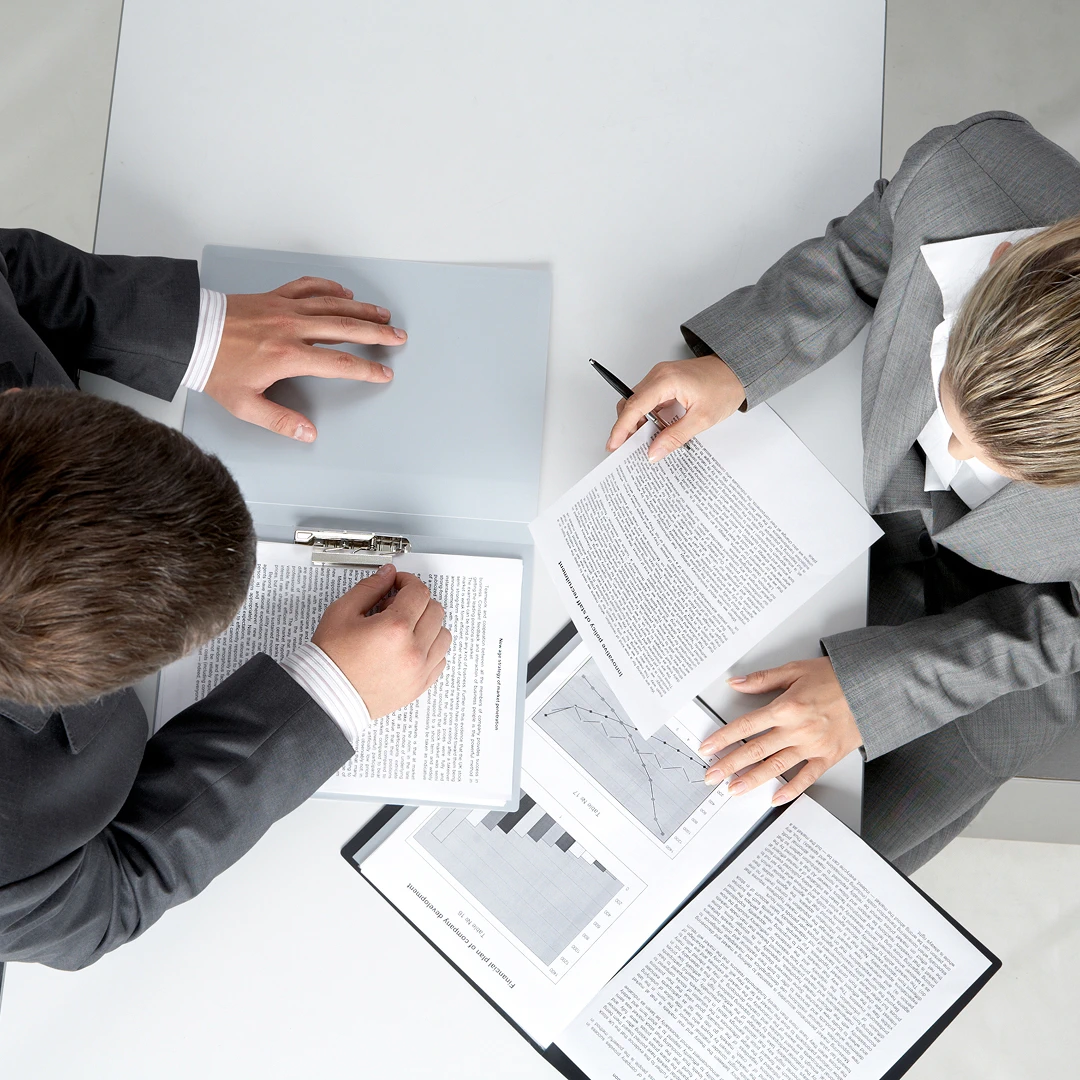 Business people reviewing documents with charts and graphs
