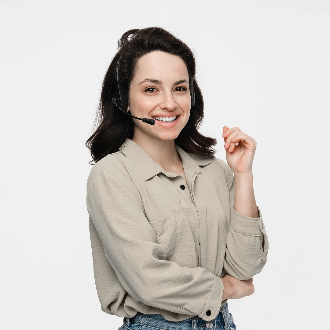 Smiling female customer support representative with dark shoulder-length hair and brown eyes, wearing a headset and a light khaki dress shirt