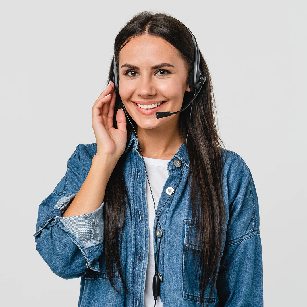 Friendly customer service representative with long dark hair and a denim shirt