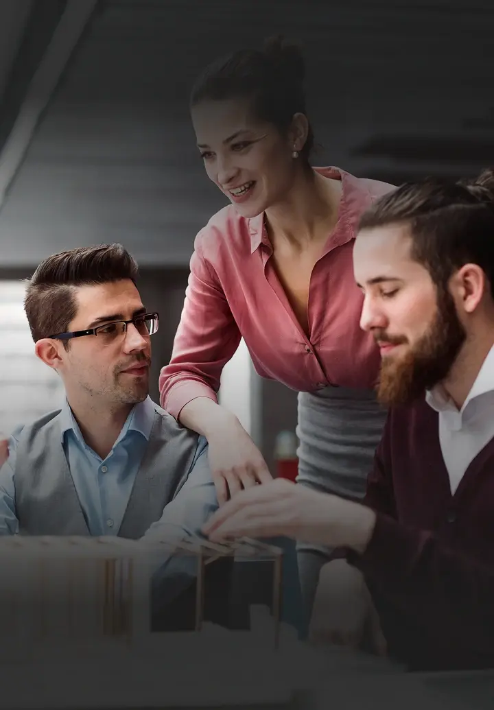 Three business people working together on a project.