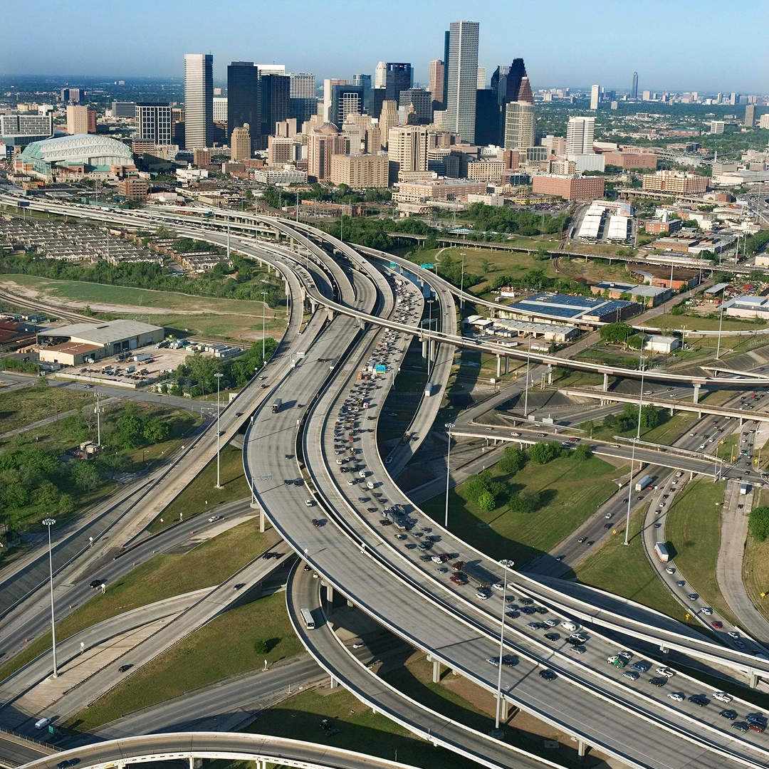 Houston, Texas, showing the city skyline and intersecting freeways with heavy traffic