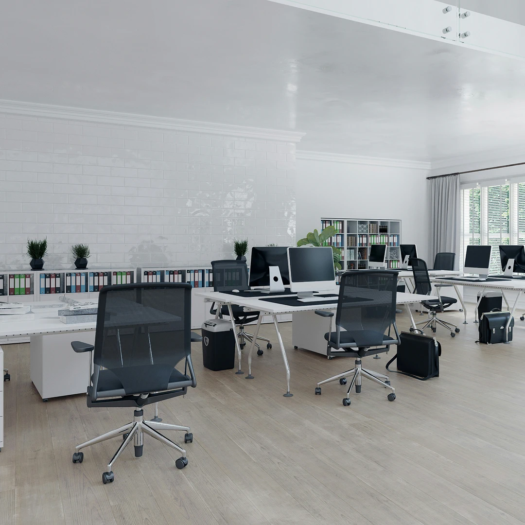 Bright minimalist office with desks, computers, ergonomic chairs, and white brick walls
