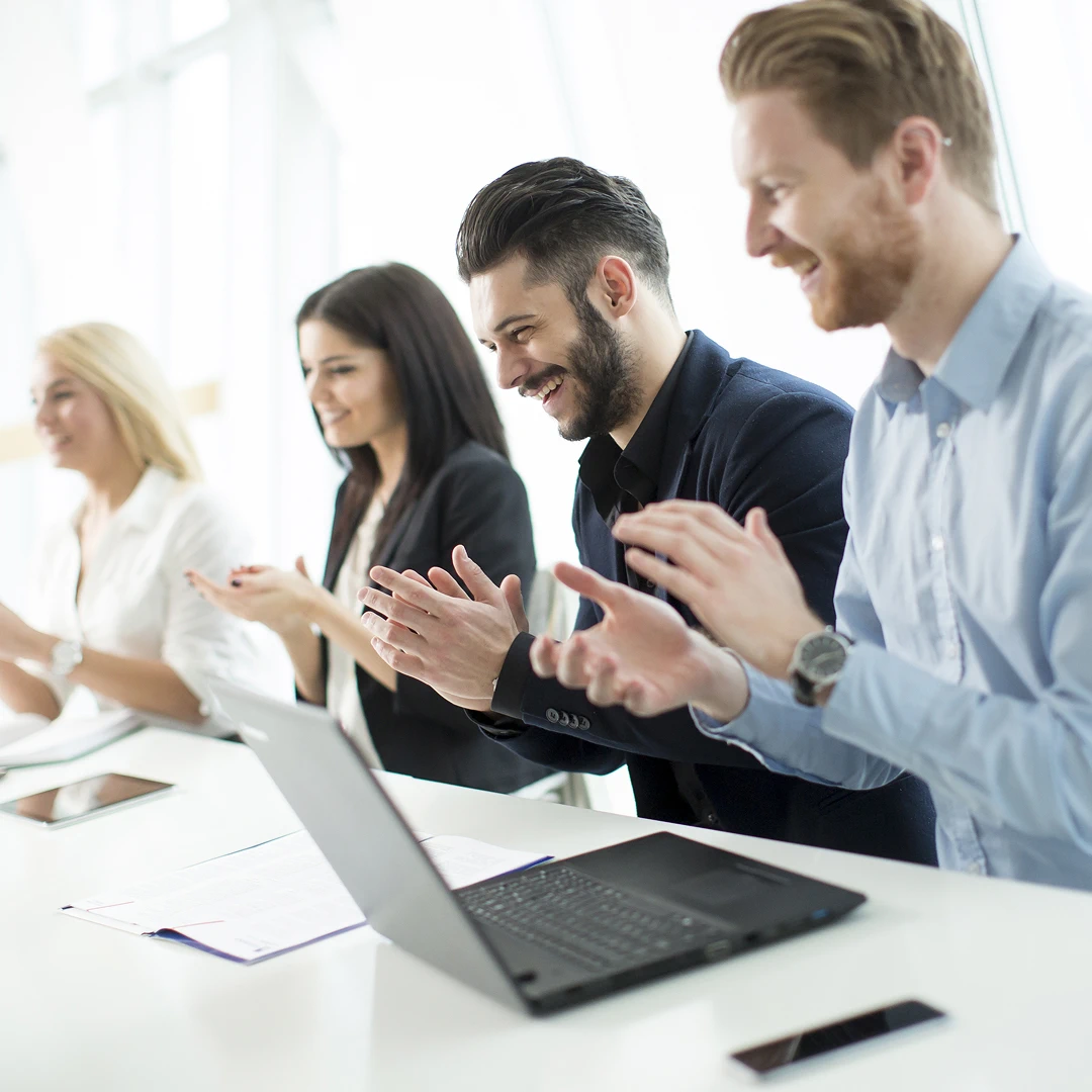 Group of business colleagues applauding together during a meeting