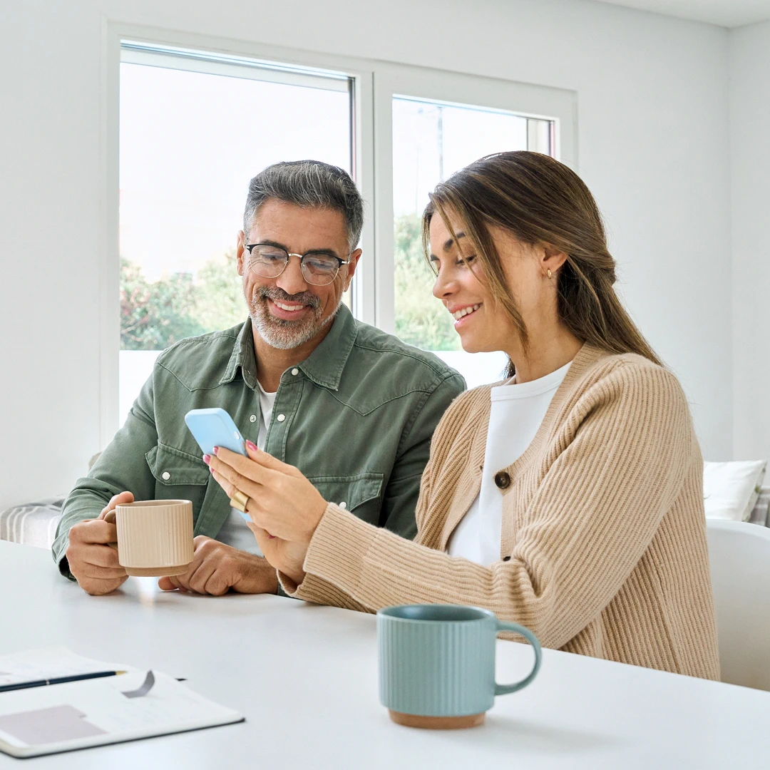 In a bright and spacious room, a man and a woman are having a pleasant conversation