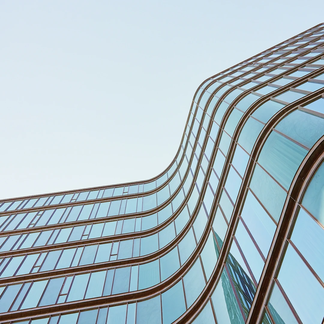 Curved building exterior with many windows