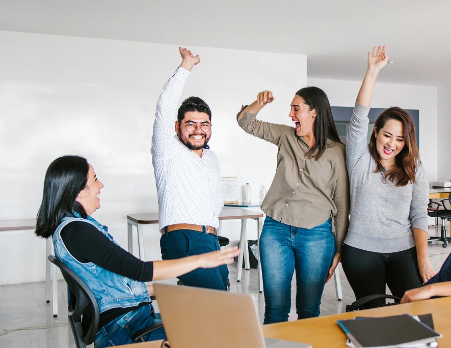 Helpware Mexico team celebrates success with raised hands and team spirit