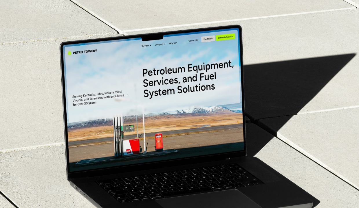 Laptop with an open screen showcasing the Petro Towery website homepage.