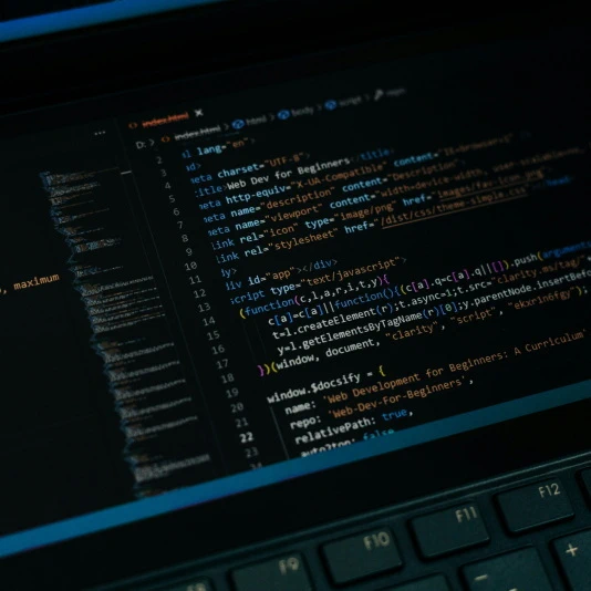 a laptop with many lines of code on the screen