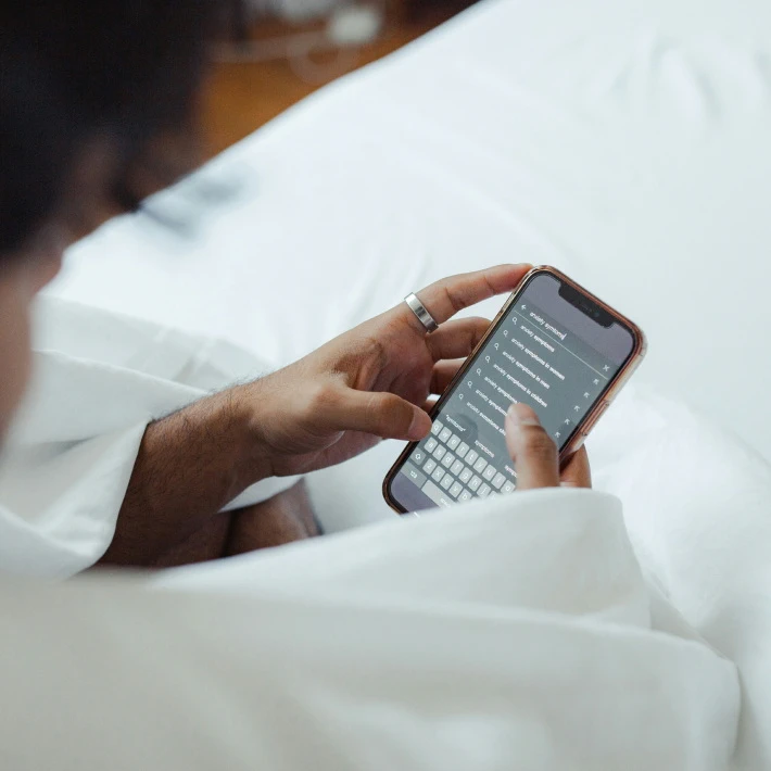 a man googling anxiety symptoms on his iphone