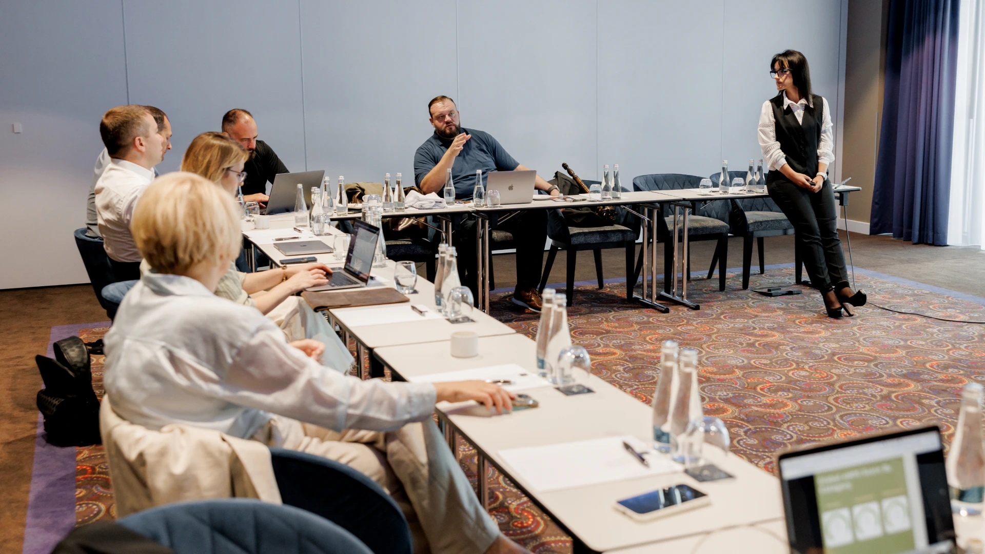 Helpware leadership team members at a business meeting in a large conference hall