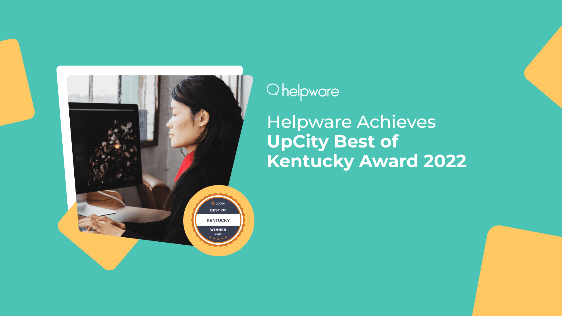 Professional woman with long black hair working at a desktop in an office, accompanying the announcement ‘Helpware Achieves UpCity Best of Kentucky Award 2022