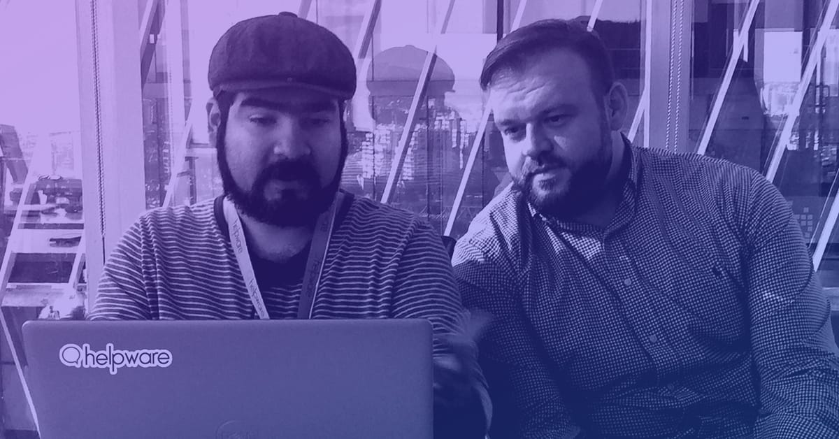 Two men are reviewing information on a laptop, and one of them is Robert Nash, the CEO of Helpware