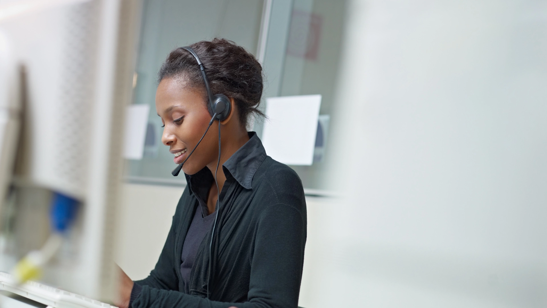 Professional woman wearing a headset, representing efficient and friendly customer support.