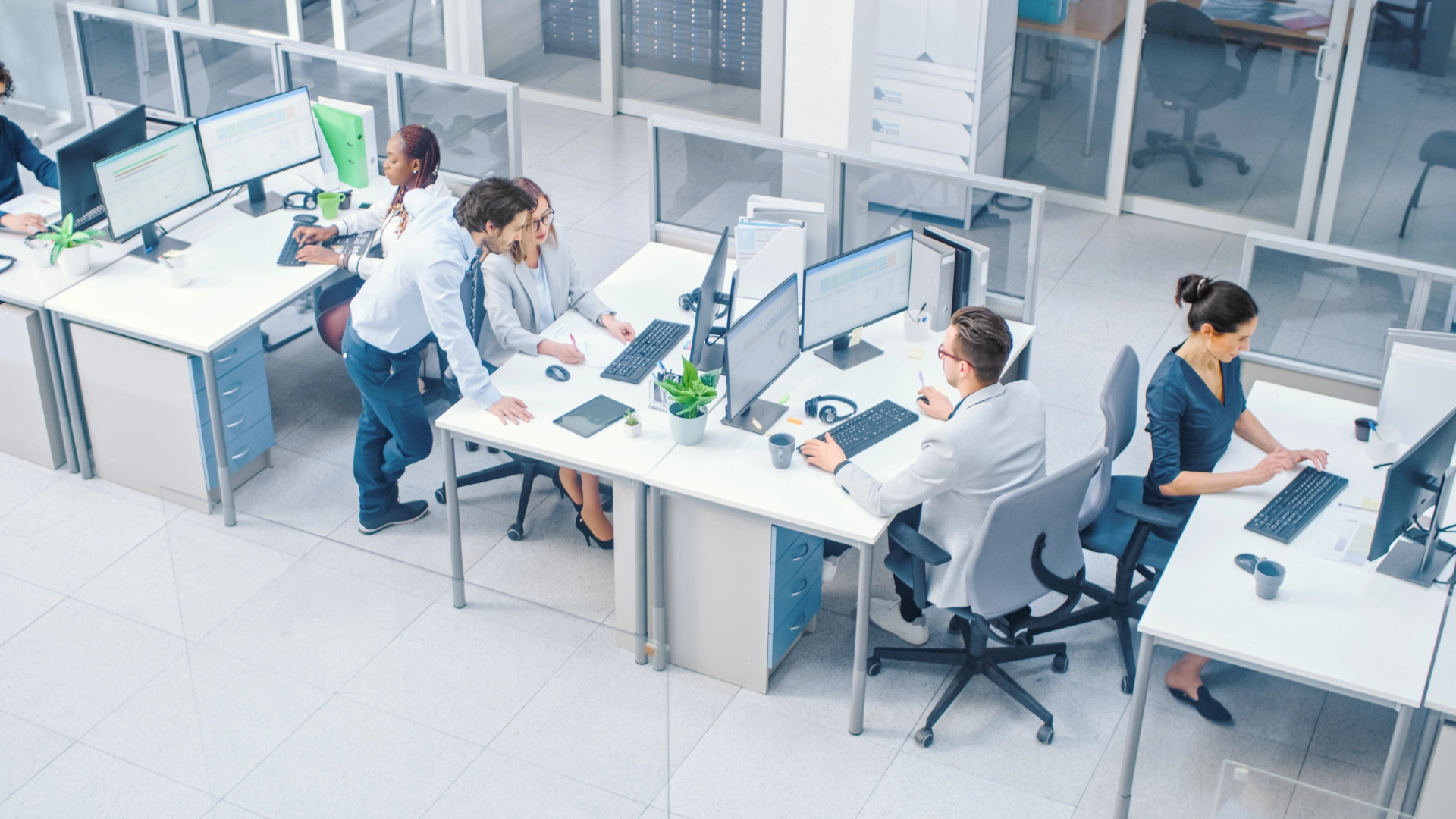 Modern office space with employees working at their desks.