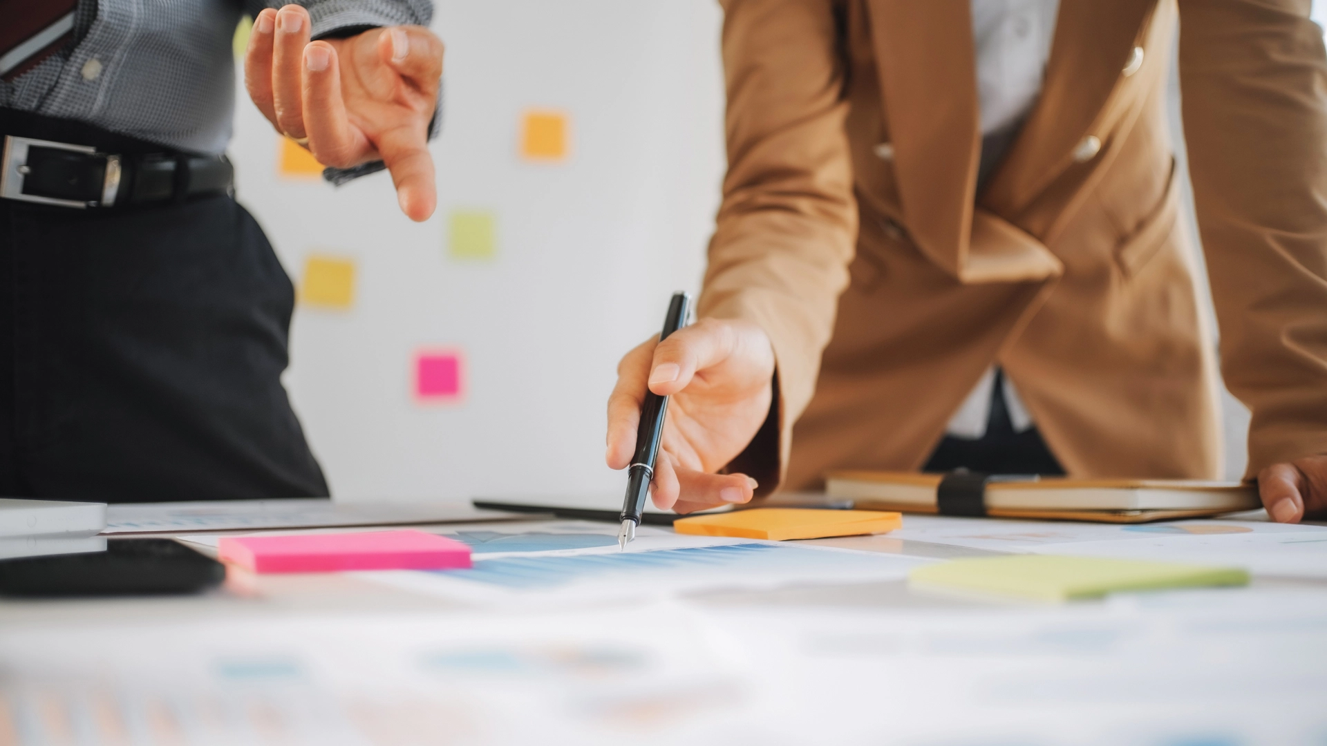 Business professionals analyzing charts and planning strategy.