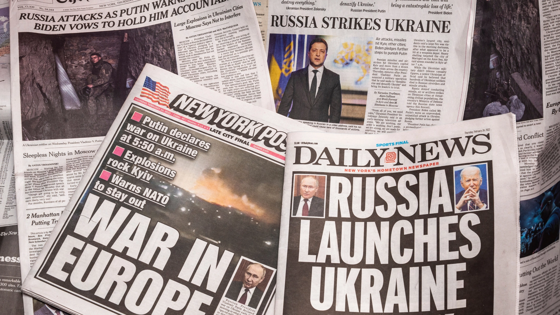 Newspapers with headlines about the war in Ukraine.