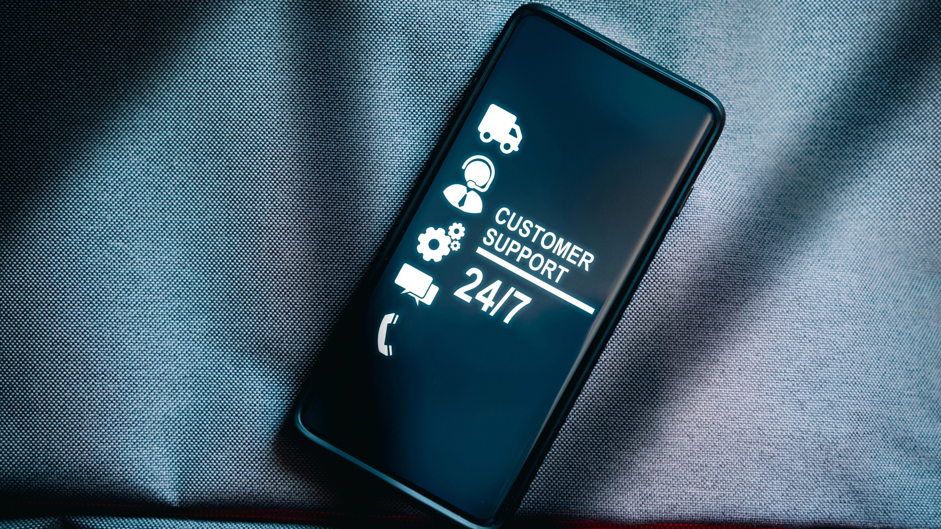 Smartphone display showing 'Customer Support 24/7'.